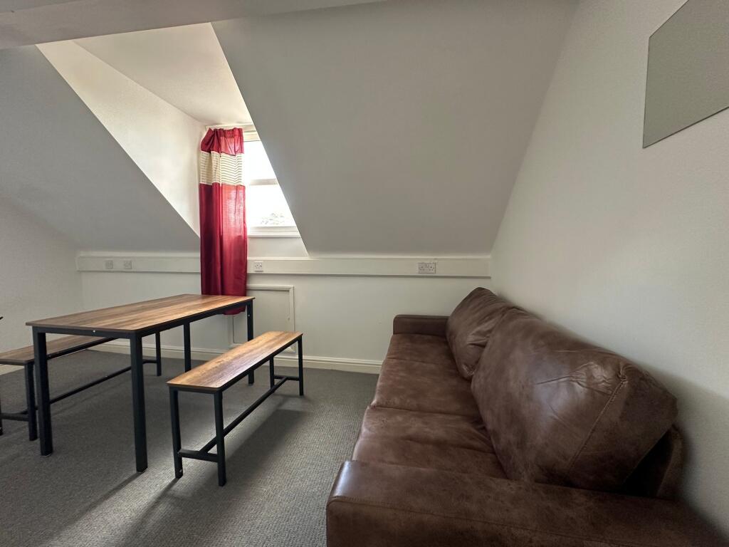 A cozy communal lounge featuring a comfortable ...