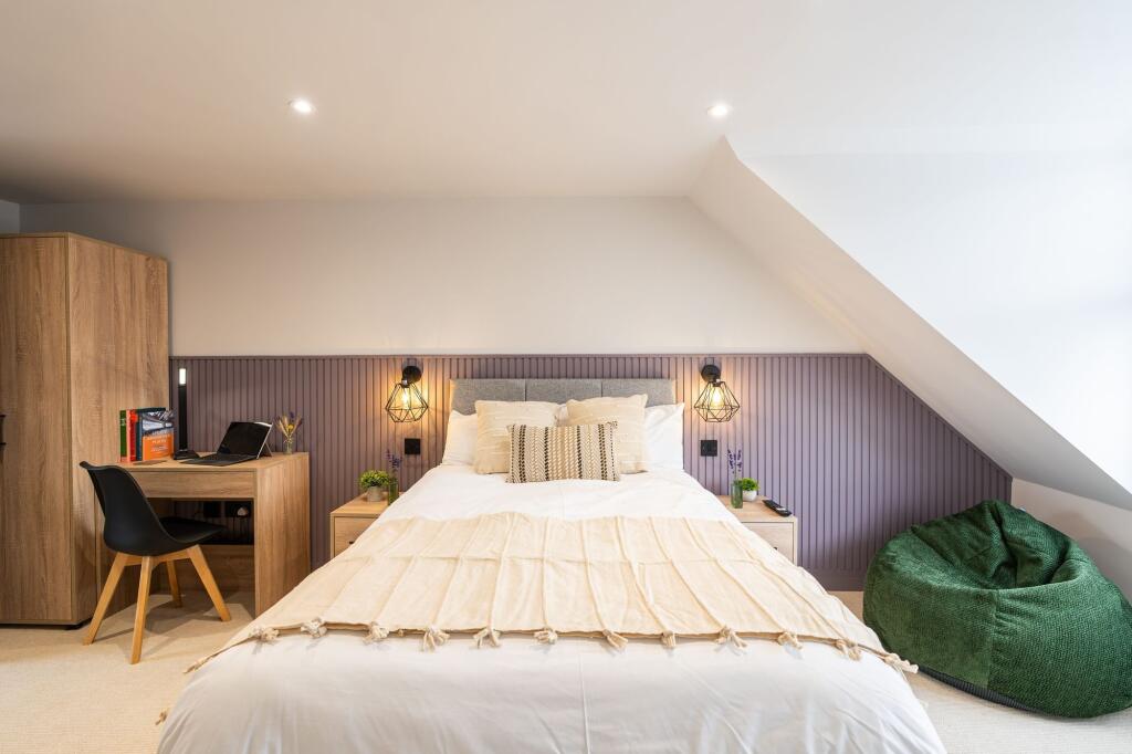 Bright and stylish master bedroom featuring a c...