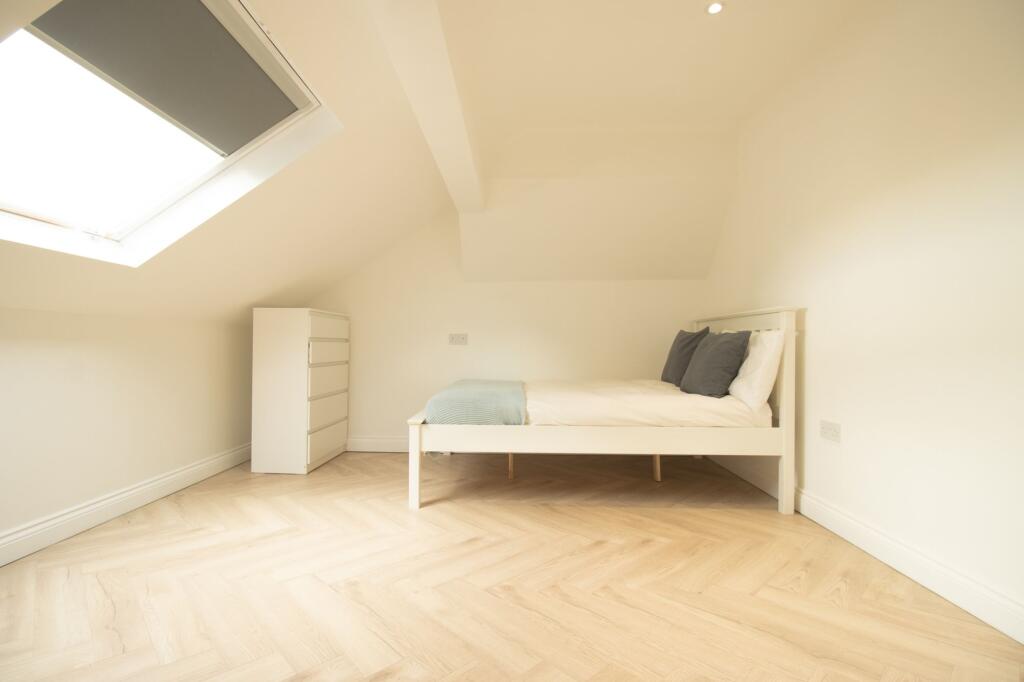 Bright and airy bedroom featuring neutral decor...