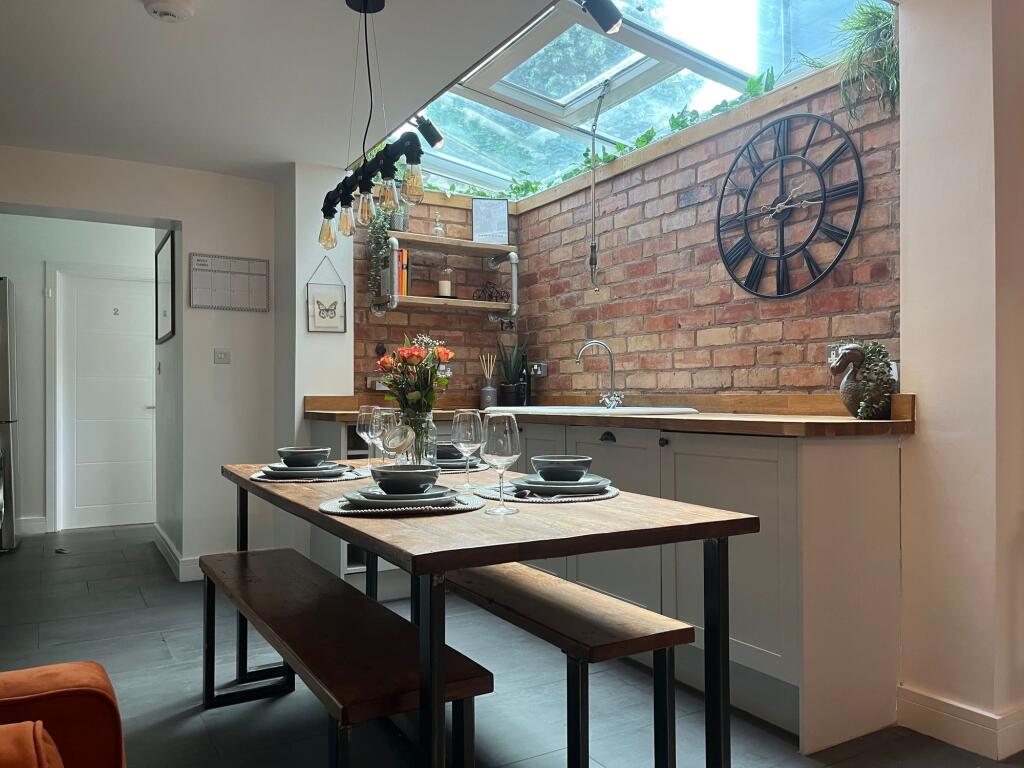 Modern kitchen featuring a wooden dining table ...