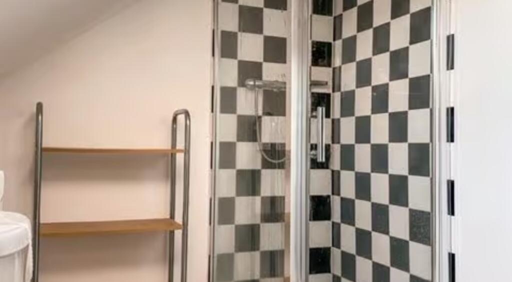 A modern bathroom featuring a stylish black and...