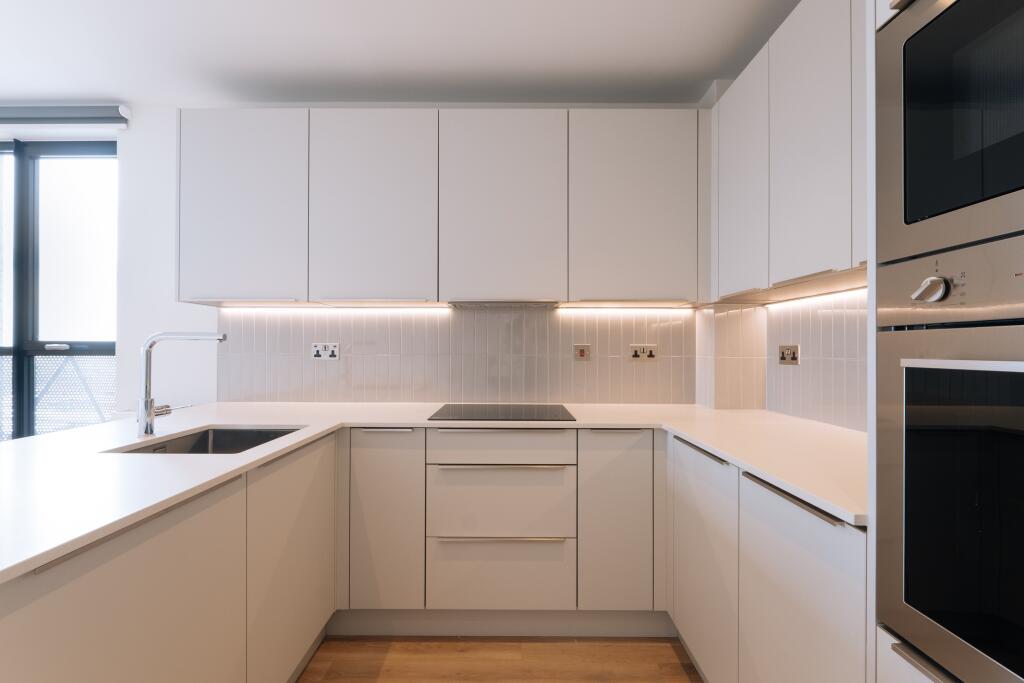 Explore the elegance of this modern kitchen, designed to merge style with functionality.