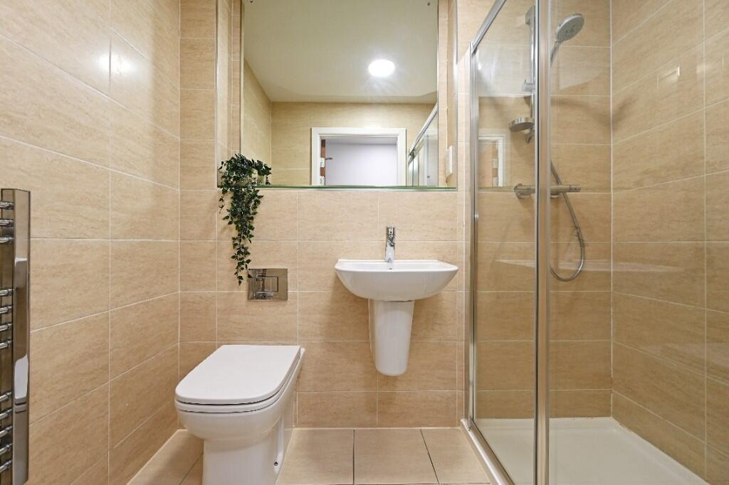 A modern and well-maintained bathroom suite wit...
