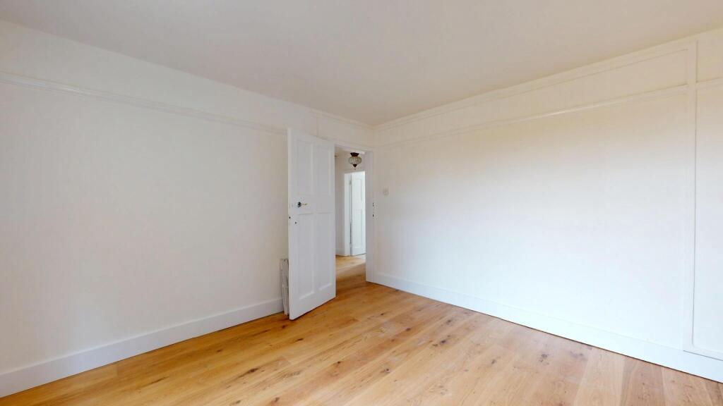 A bright and spacious living room with wooden f...