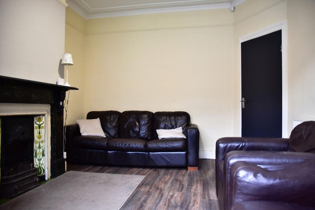 Spacious living room featuring comfortable leat...