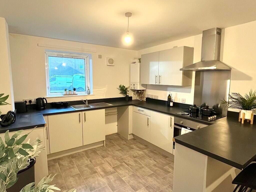 Bright and modern kitchen featuring ample count...