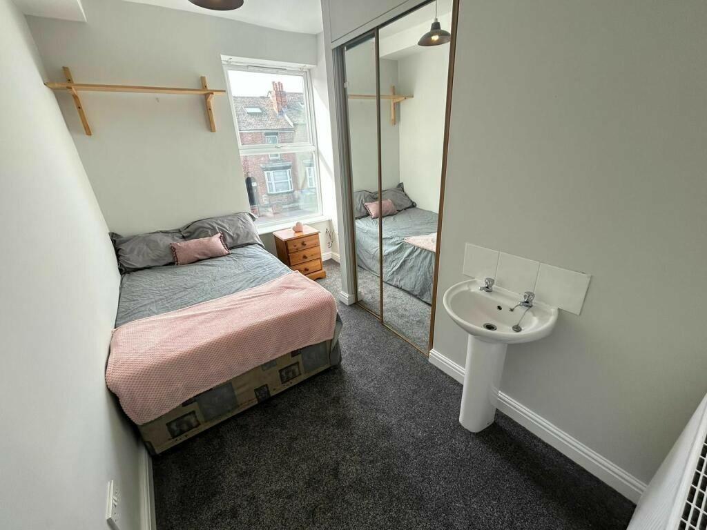 A compact and clean single toilet room featurin...
