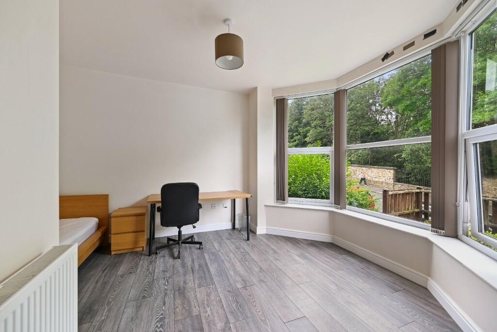 Bright single bedroom featuring a large bay win...