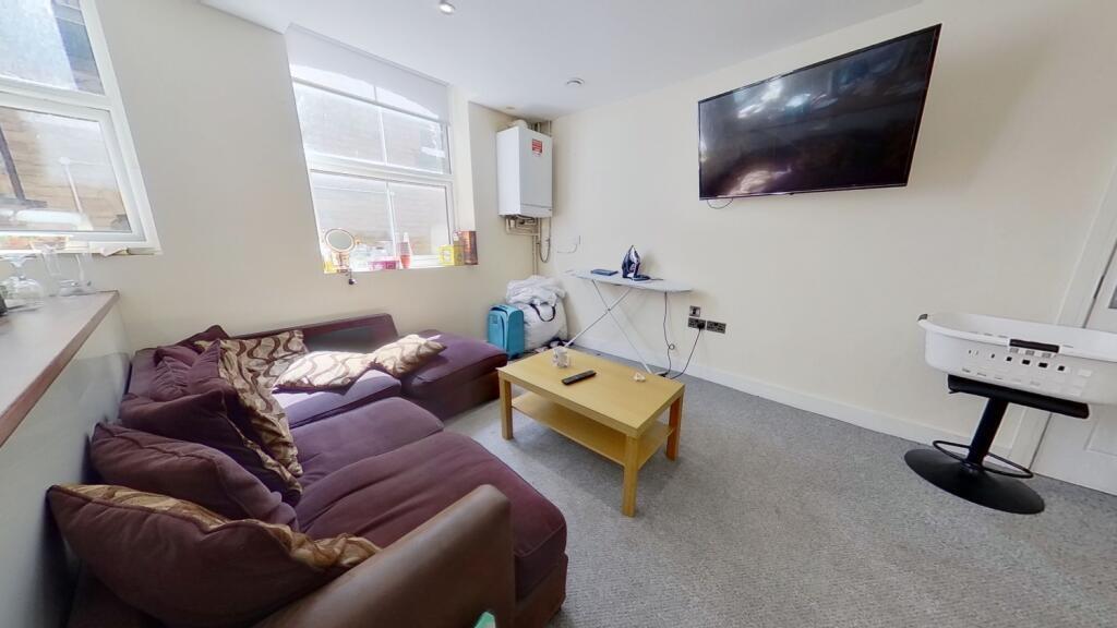 Bright and cozy living room featuring a comfort...