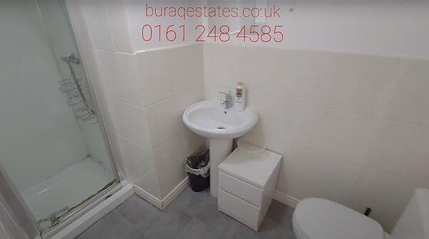 A clean and functional bathroom featuring a sho...