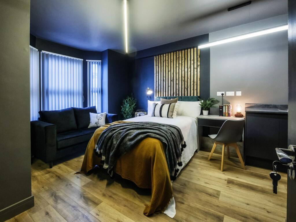 A stylish double bedroom featuring a cozy doubl...