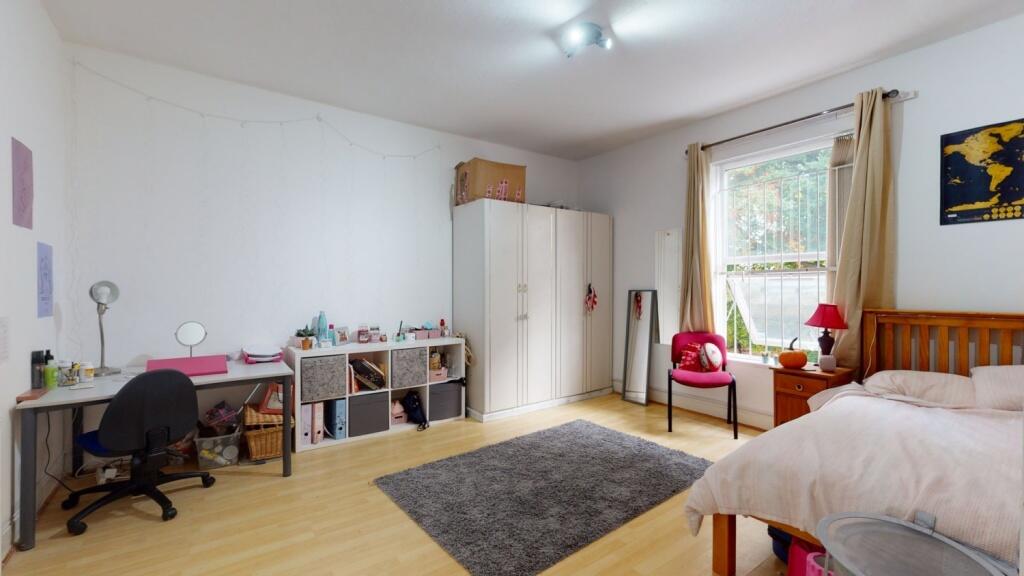 Bright and spacious master bedroom featuring a ...