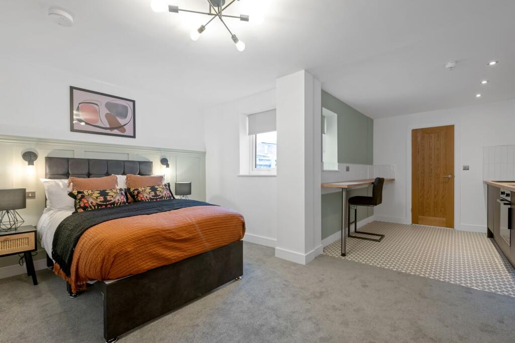 A modern, well-lit living room with stylish dec...