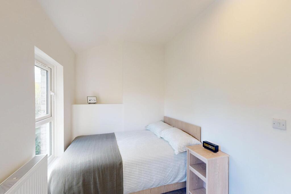 Bright and airy master bedroom featuring a doub...