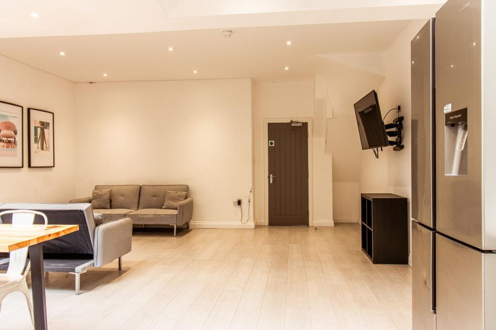 Bright, modern open-plan living area with light...