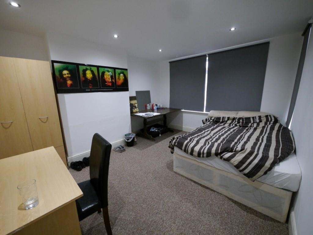 A neat and functional student bedroom featuring...