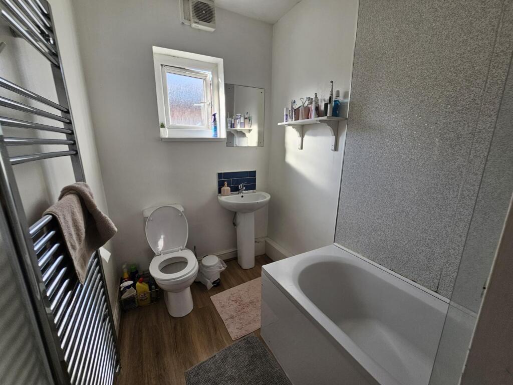A bright and well-maintained bathroom featuring...