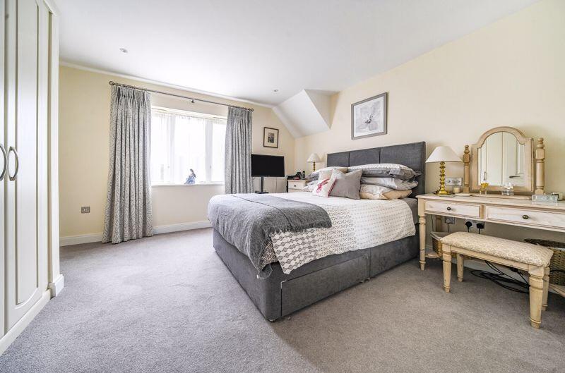 Master bedroom with fitted wardrobe a...