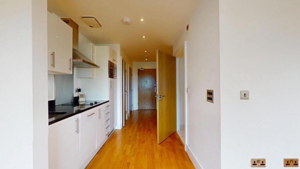 A clean and bright hallway with polished wooden...