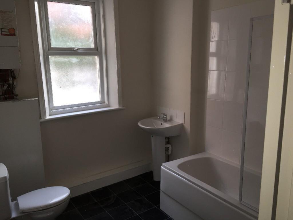 A clean and functional bathroom featuring a bat...