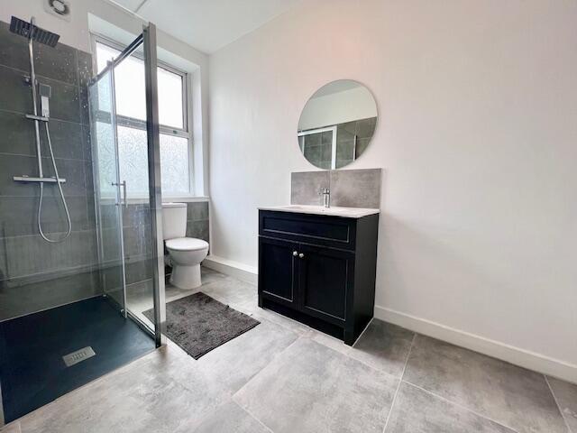 Bright and modern bathroom featuring a spacious...