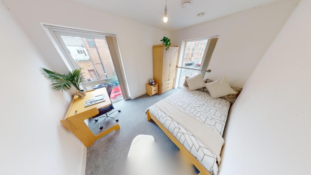 Bright and airy double bedroom featuring a comf...