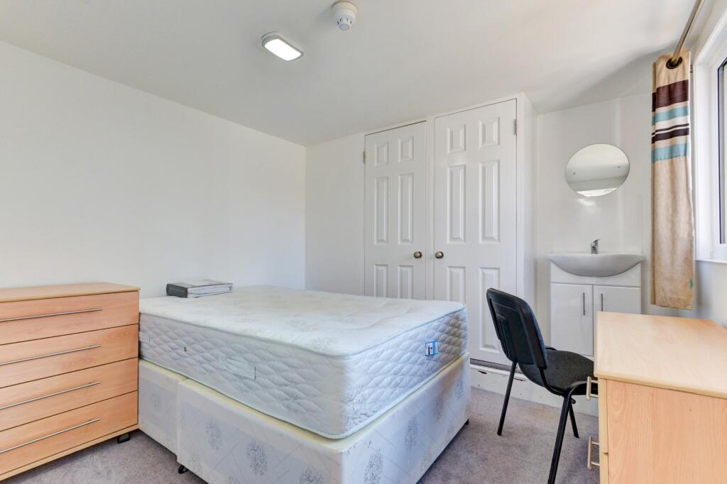Bright and tidy bedroom featuring a comfortable...