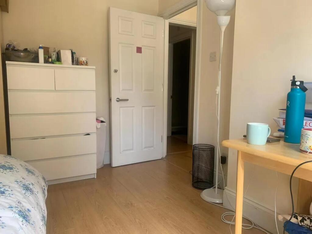 A tidy and softly lit room featuring light wood...