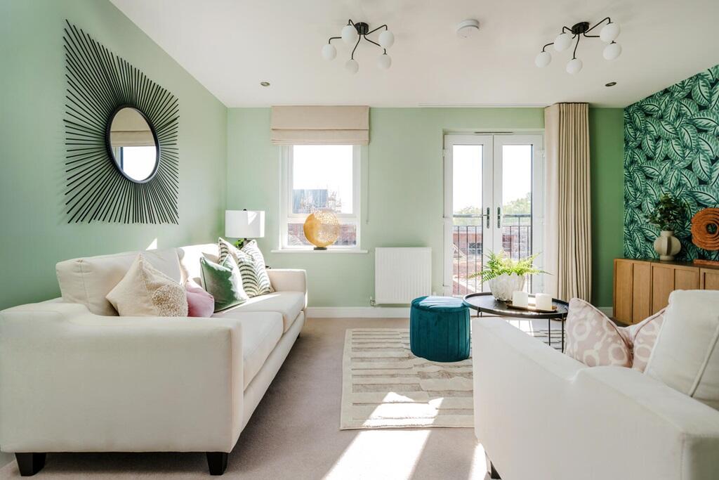 The spacious living room has a Juliet balcony and plenty of room for two sofas