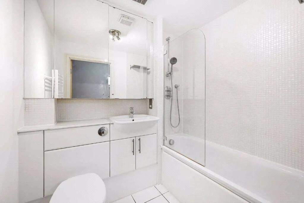 Bright and modern bathroom featuring a clean wh...