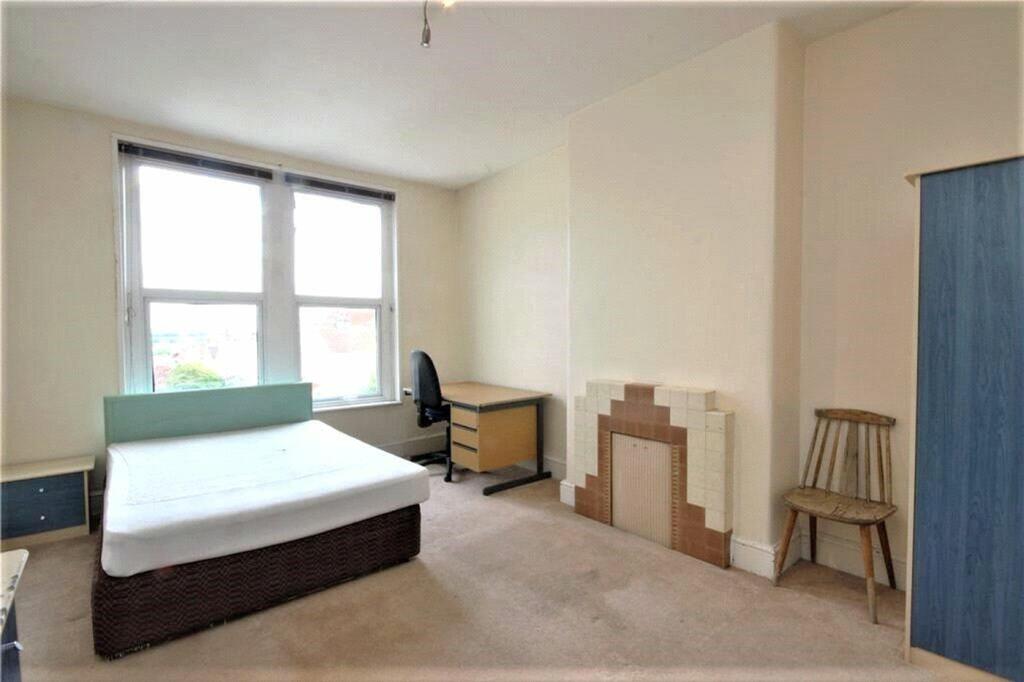 Spacious double bedroom featuring large windows...