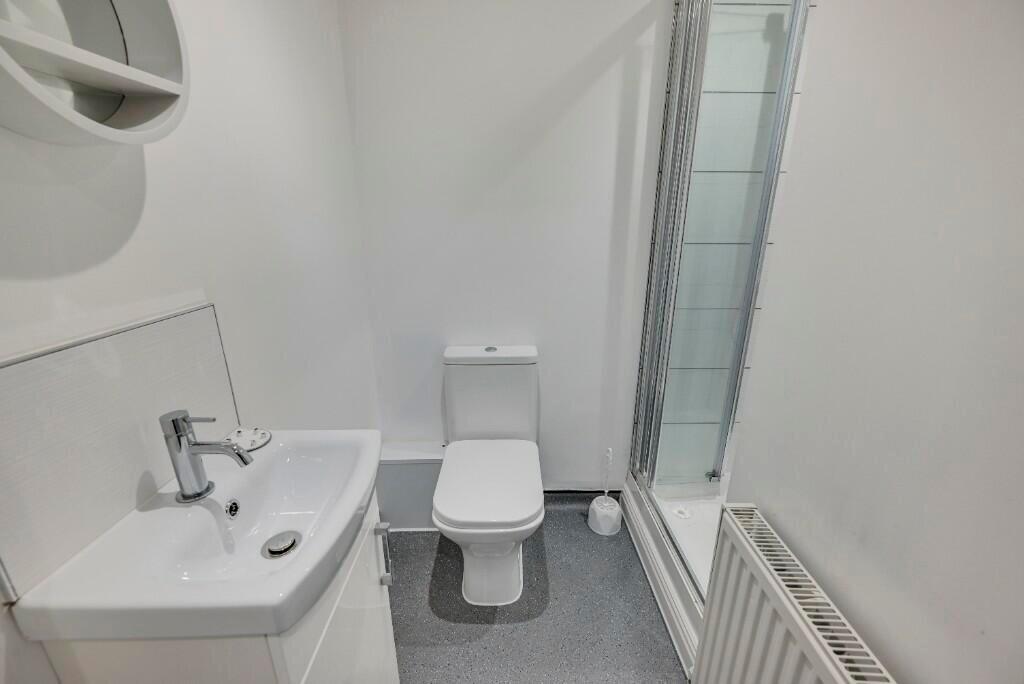 A clean and modern single toilet area featuring...
