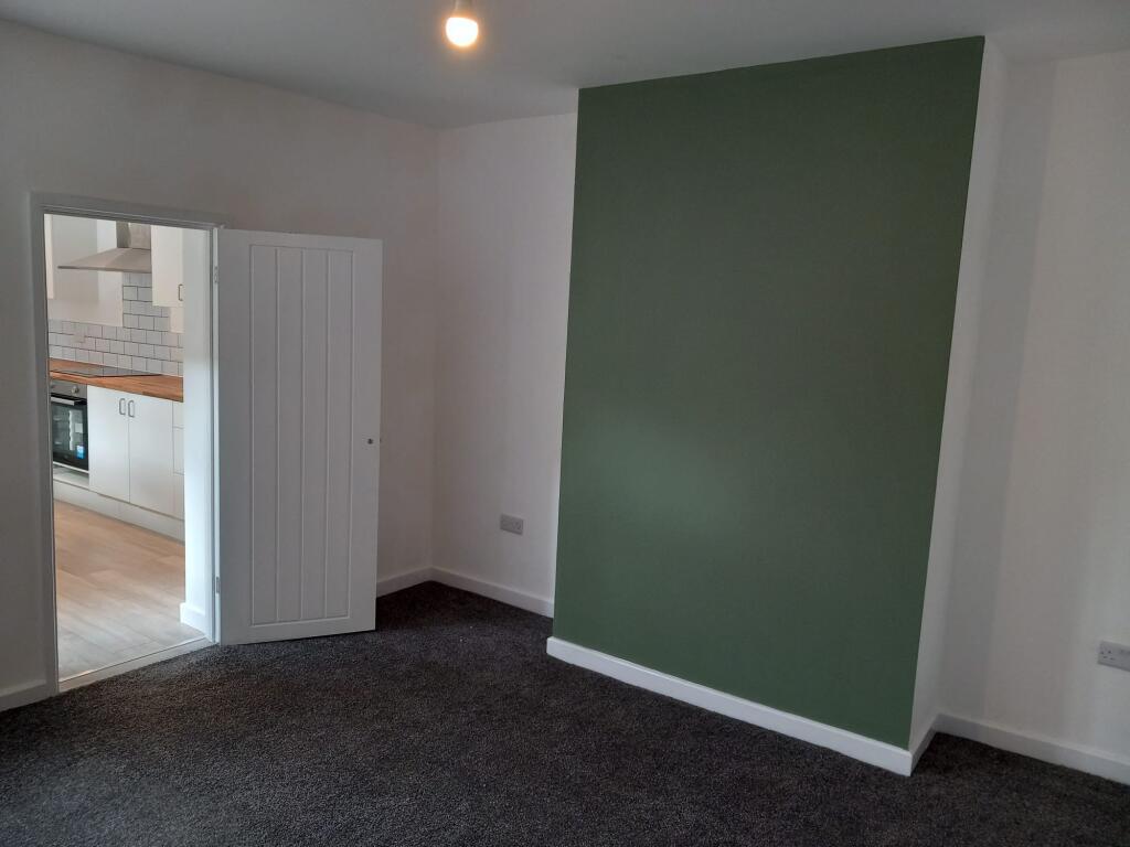 A clean and neat double bedroom featuring a sty...