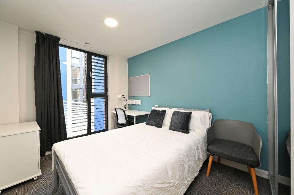 Bright and modern double bedroom featuring a co...