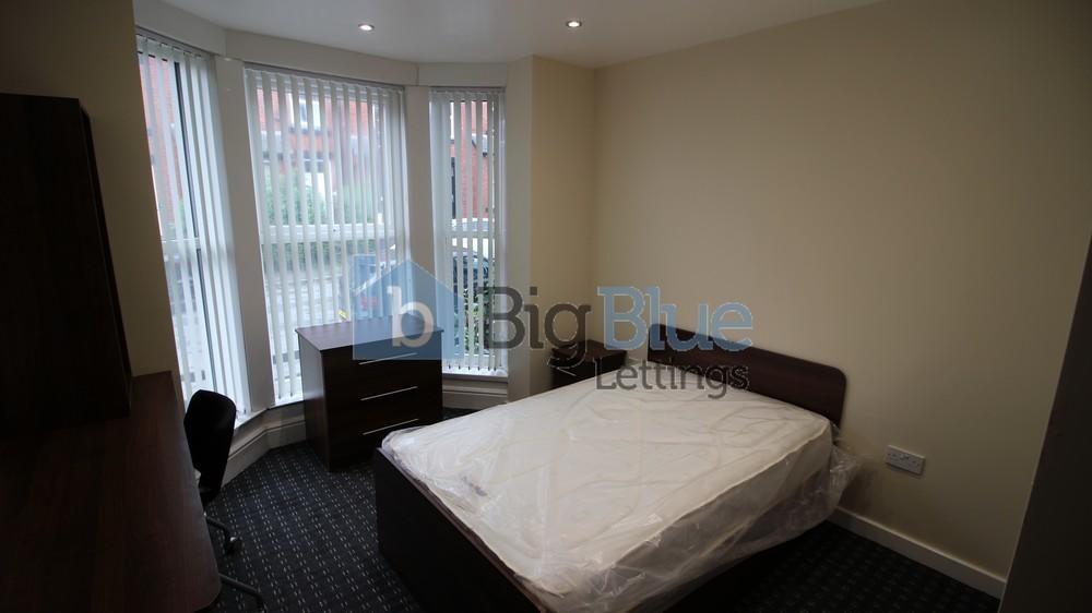 A bright and neatly kept double bedroom featuri...