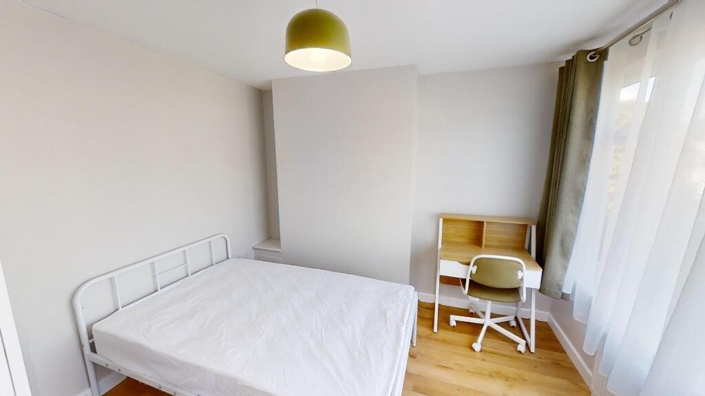 Bright and neat bedroom featuring a comfortable...