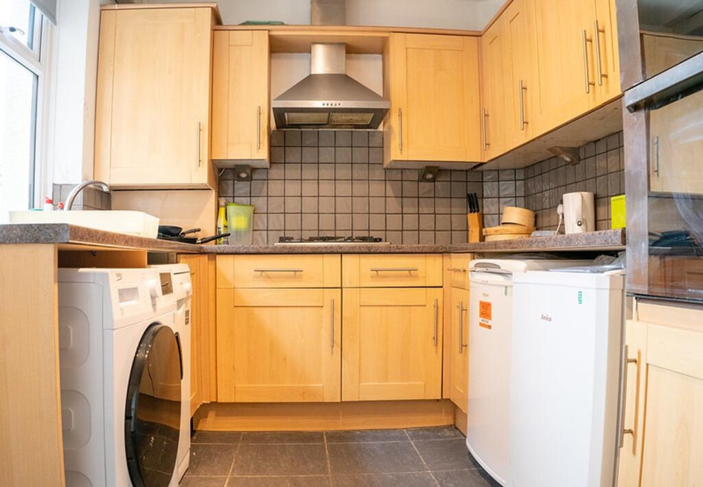A bright and tidy kitchenette with modern appli...