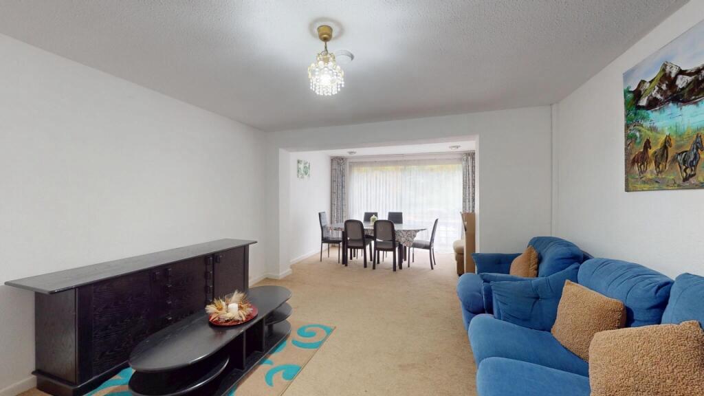 A contemporary living room featuring a comforta...