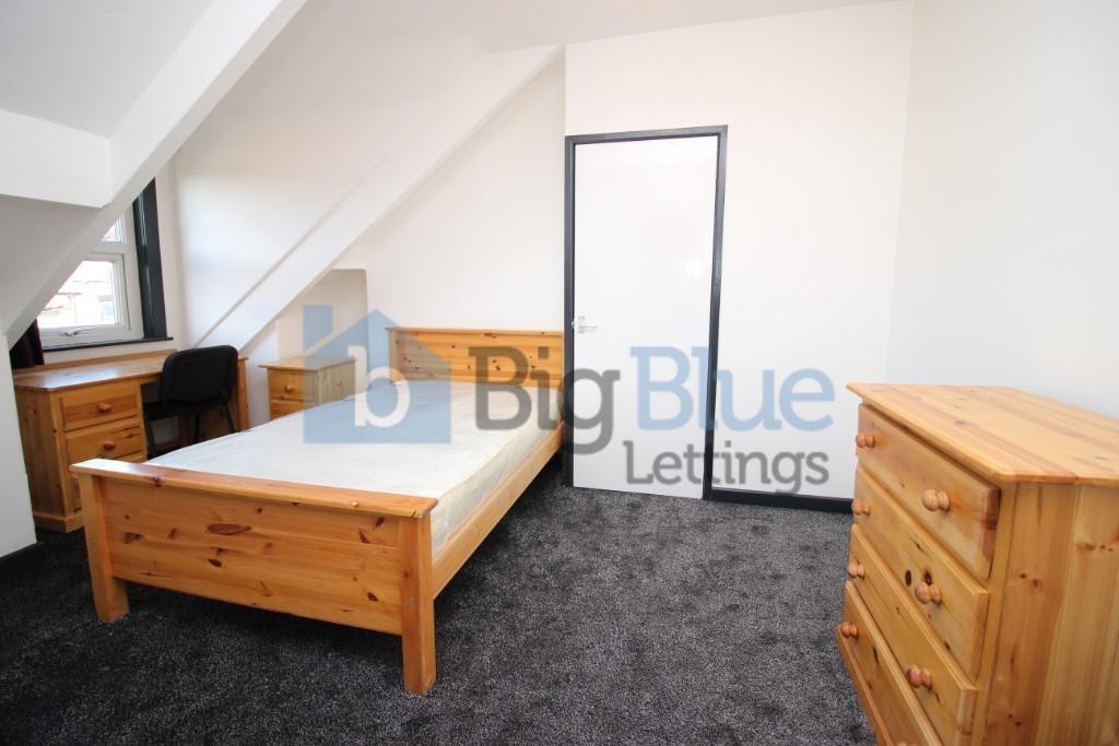 A bright and tidy double bedroom featuring a wo...