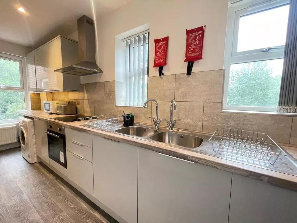Bright and modern kitchen featuring sleek cabin...