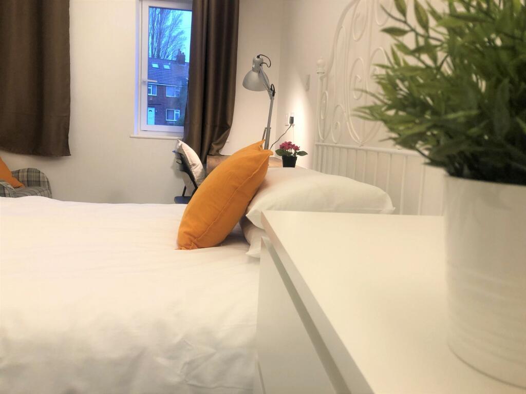 Bright and cozy single bedroom with a large win...