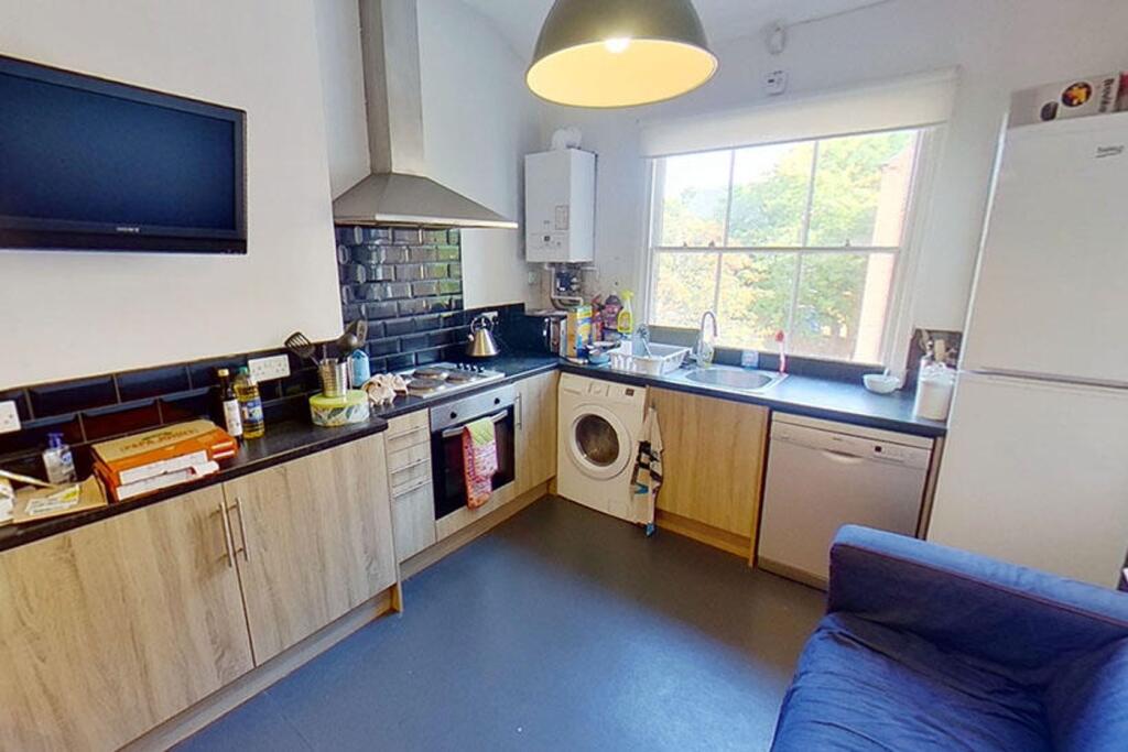 Bright and modern kitchen featuring ample count...