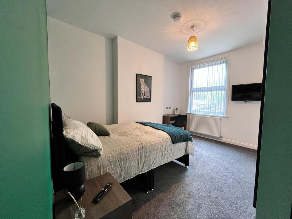 A spacious and inviting double bedroom featurin...