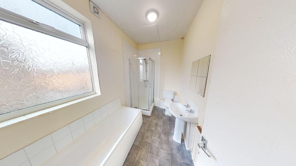 Bright and clean bathroom featuring a full-size...