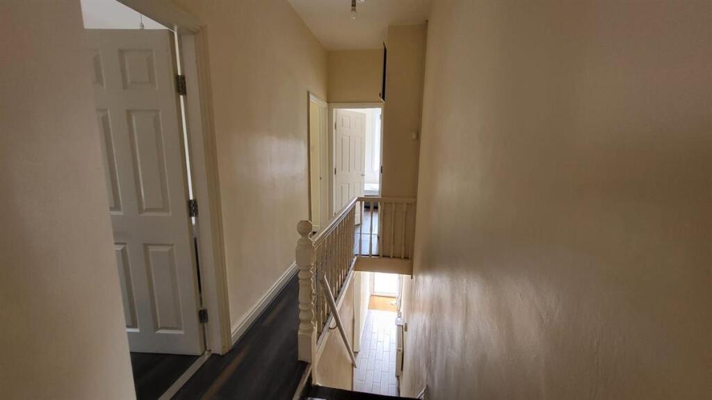 Bright first-floor landing with neutral walls, ...