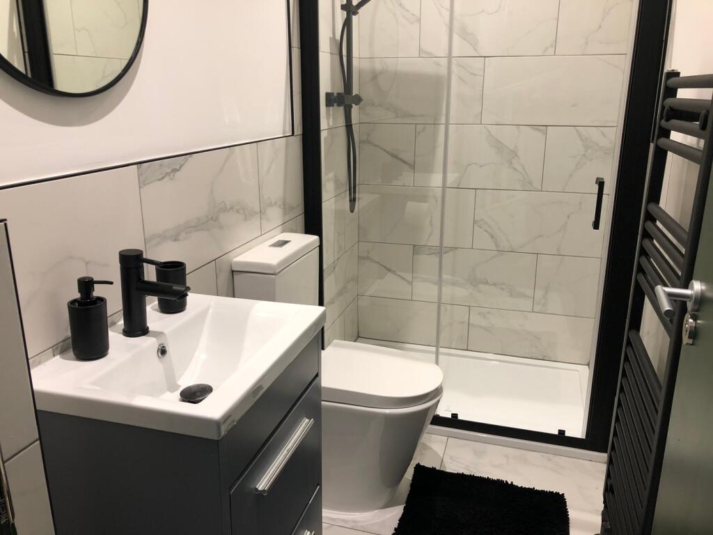 A modern and stylish bathroom featuring sleek f...