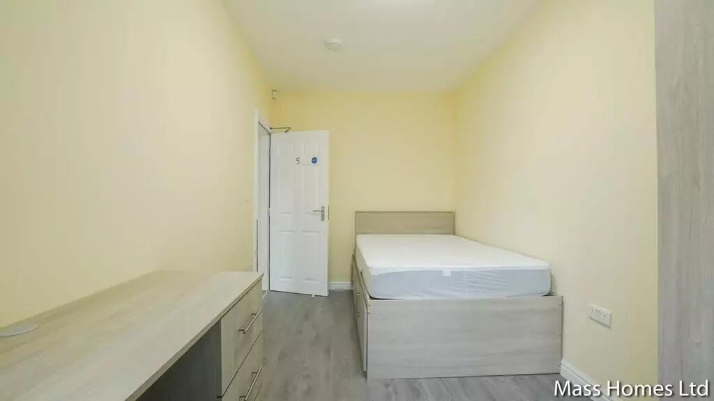 A clean and tidy single bedroom with neutral cr...