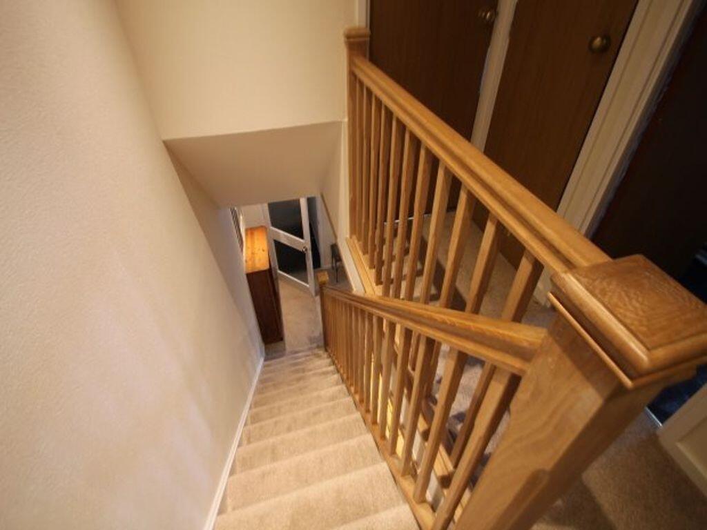 Carpeted internal staircase with sturdy wooden ...