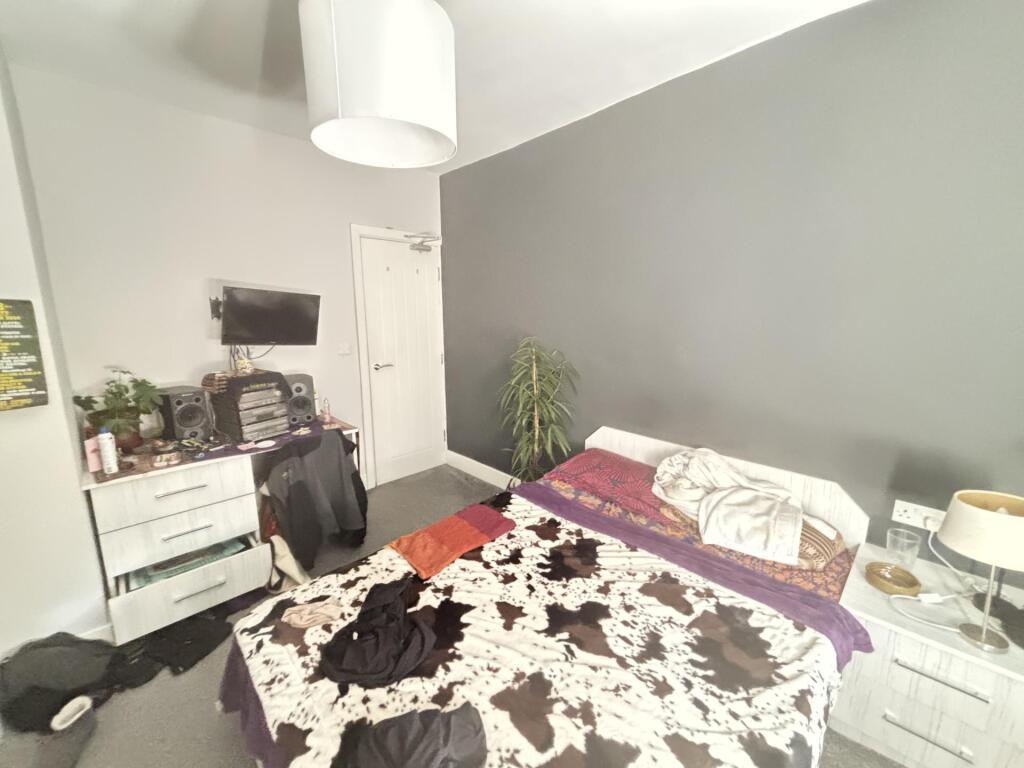 A well-maintained bedroom featuring a double be...
