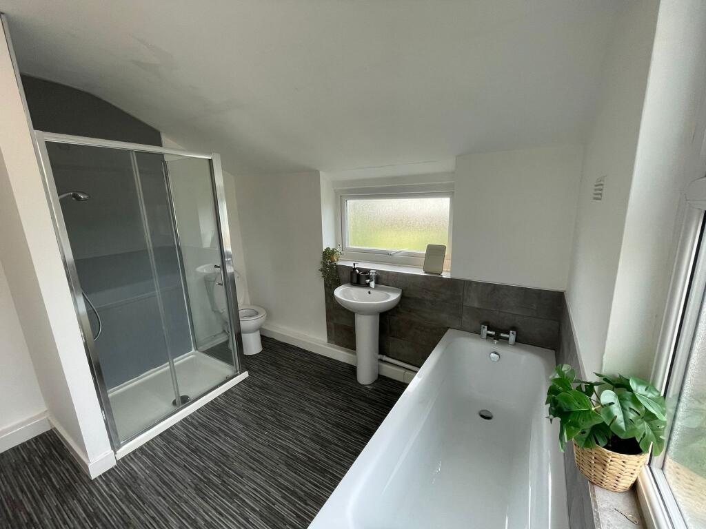 Modern and bright bathroom featuring a spacious...
